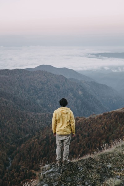 Caucasian man standing in remote mountain landscape