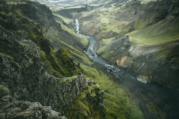Scenic view of river in green valley