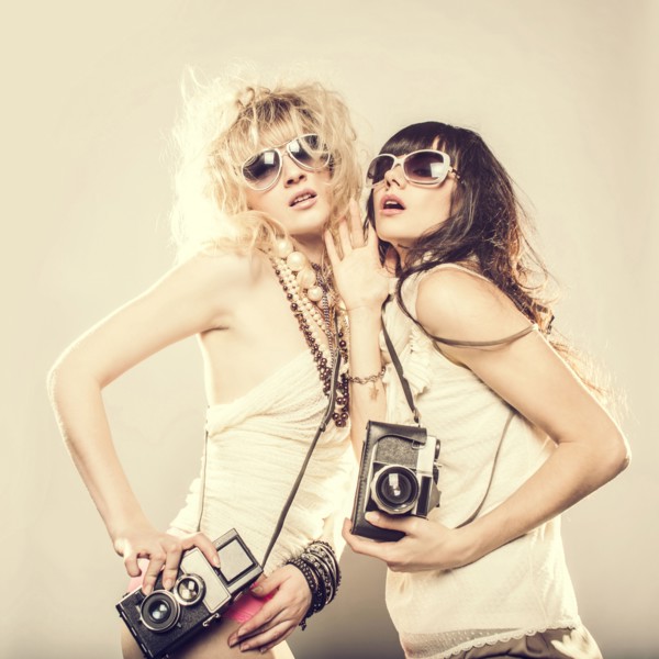 Caucasian women posing with cameras