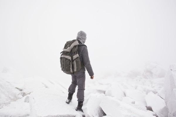 Caucasian man hiking in snow