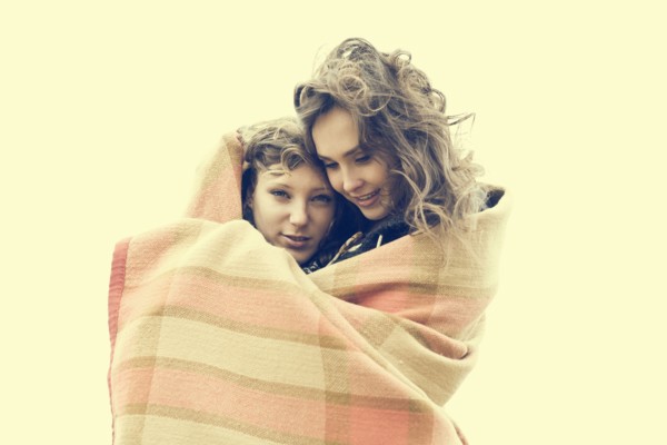 Caucasian women wrapped in blanket