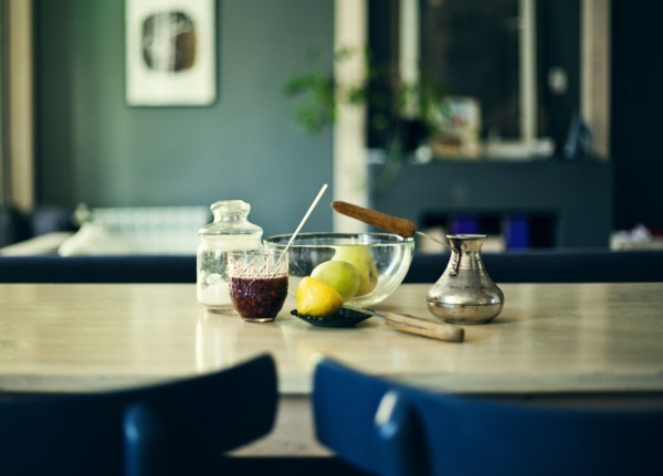 Bowl of fruit with jam and sugar on table