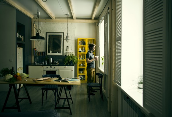 Caucasian man looking out kitchen window