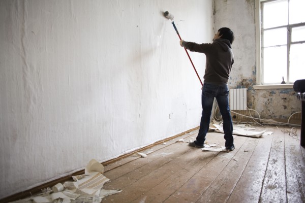 Mari man painting walls in new home
