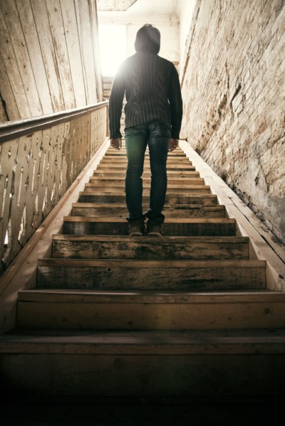Mari man standing on staircase