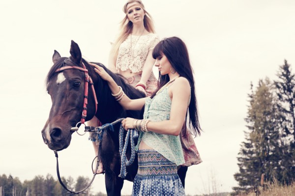 Caucasian women petting and riding horse outdoors