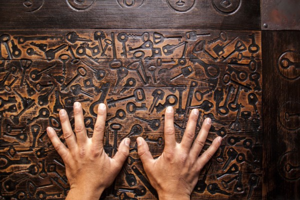 Close up of hands of Mari man hands on wooden surface
