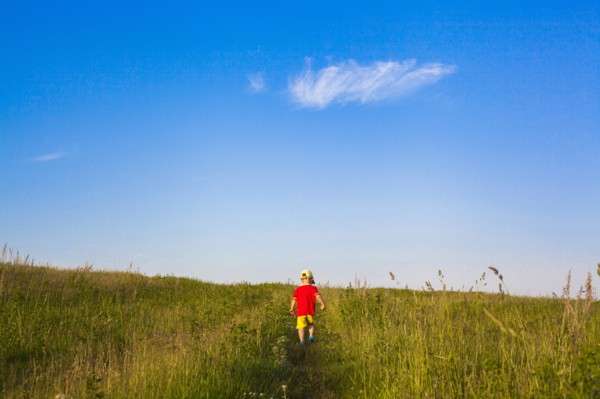 Mari boy walking in rural field