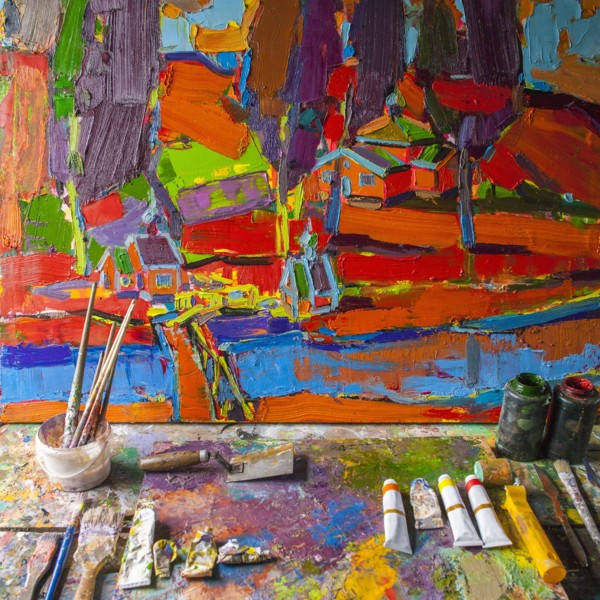 Painting on easel with paint and paintbrushes