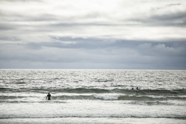Surfers in ocean waves