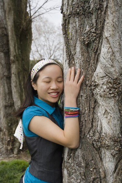Chinese girl hugging tree
