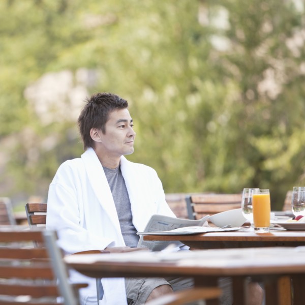 Man enjoying breakfast on outdoor patio