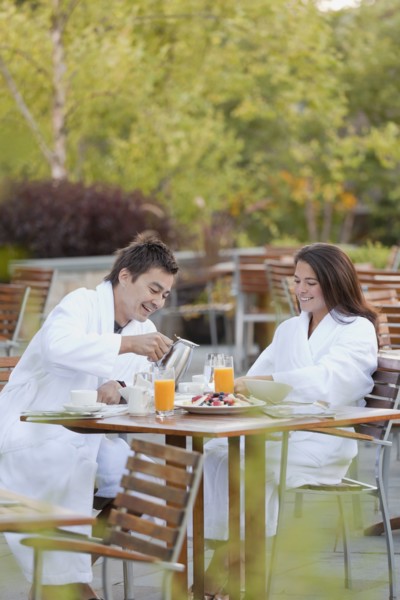 Couple enjoying breakfast on outdoor patio