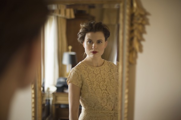 Woman wearing fancy dress looking in mirror