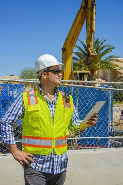 Caucasian construction worker holding digital tablet