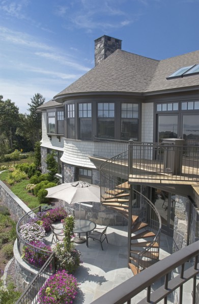 Exterior of a single family home with spiral staircase leading to yard