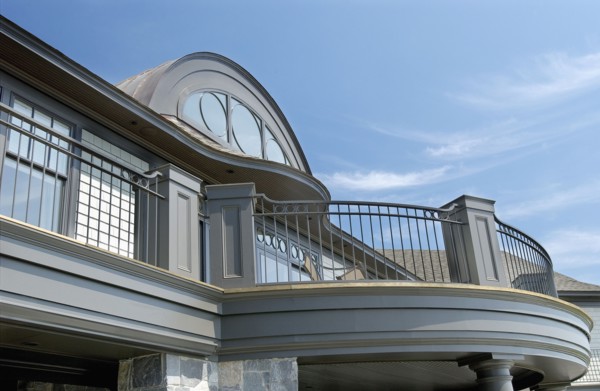Exterior of home with round top window and balcony