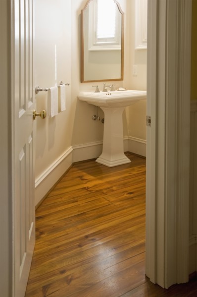 View into small bathroom with pedestal sink
