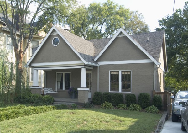 Front exterior of a one story bungalow with white trim at Nashville