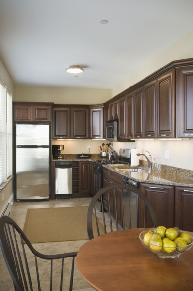 Contemporary kitchen with dark colored cabinets