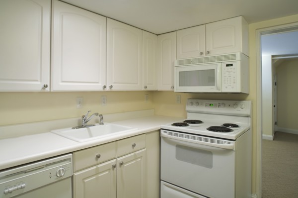 White stove and kitchen in empty apartment