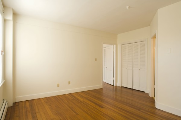 Empty room in apartment with hardwood floor