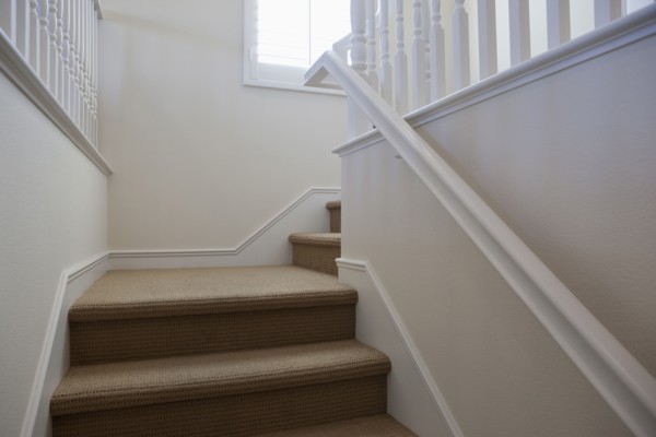 Close-up of stairs with white walls at home