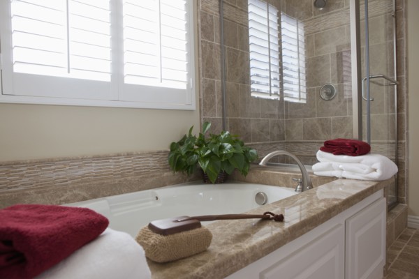 Contemporary bathroom with bath and glass shower at home