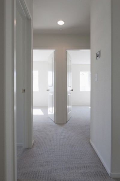Empty room with open doors and hallway at home