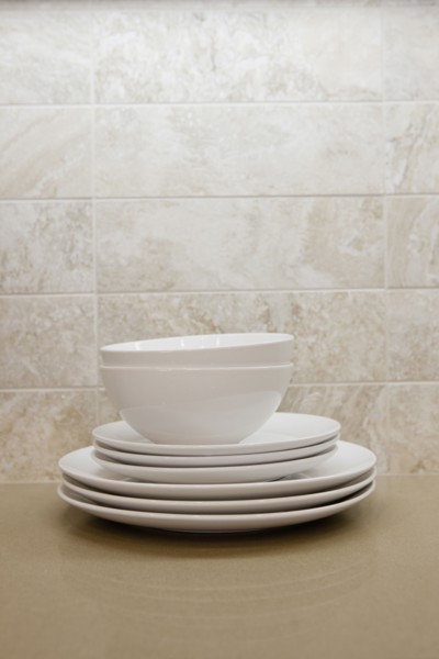 Close-up of bowls with plates in the shelf