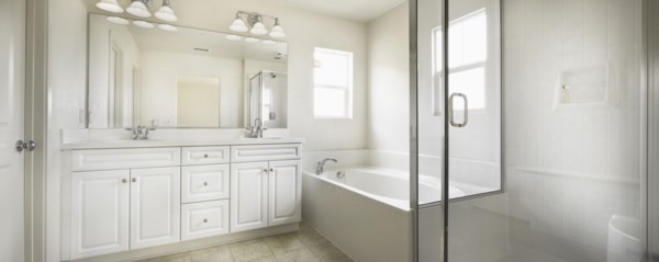 Bathroom with bath and cabinets at home
