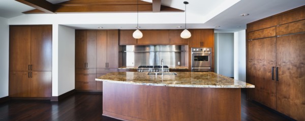 Kitchen having brown cabinets and island at home