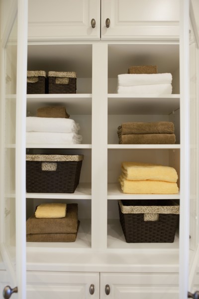 View of folded towels and baskets in shelf at home