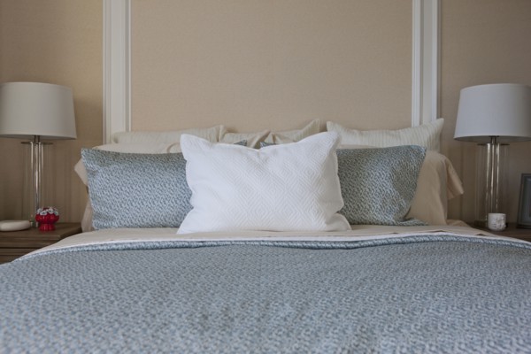 Pillows arranged on bed in middle class house