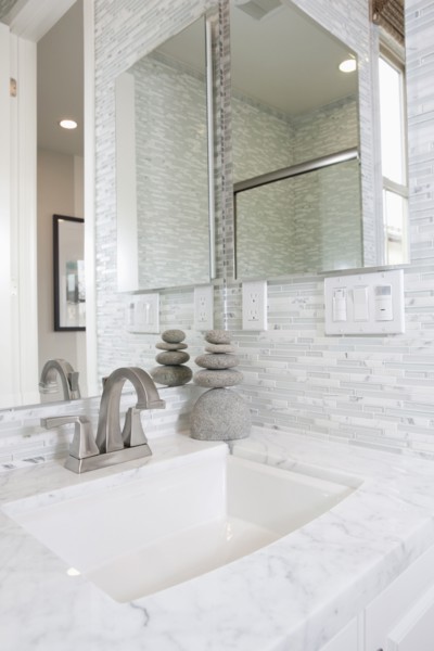 Contemporary bathroom with marble washbasin and mirror at home