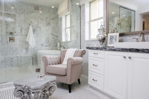 Sitting area with bathtub across the glass wall in the bathroom