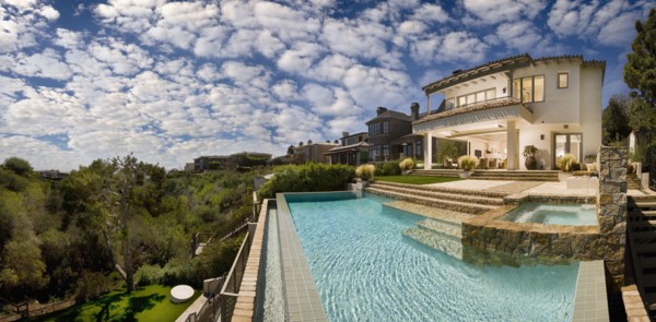 Swimming pool behind multiple story contemporary home