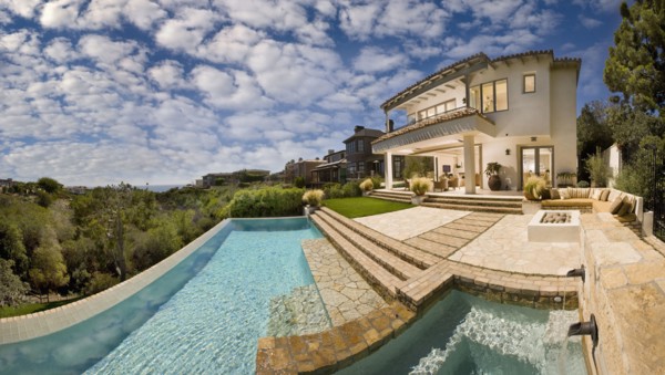 Swimming pool behind multiple story contemporary home