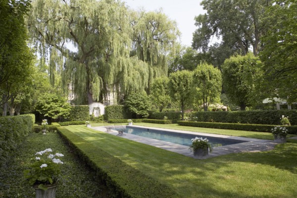 Formal shaped hedge garden with narrow pool