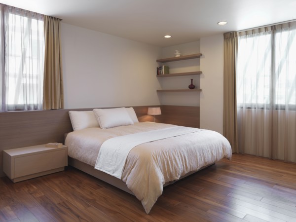 Simple minimalist bedroom with hardwood floors