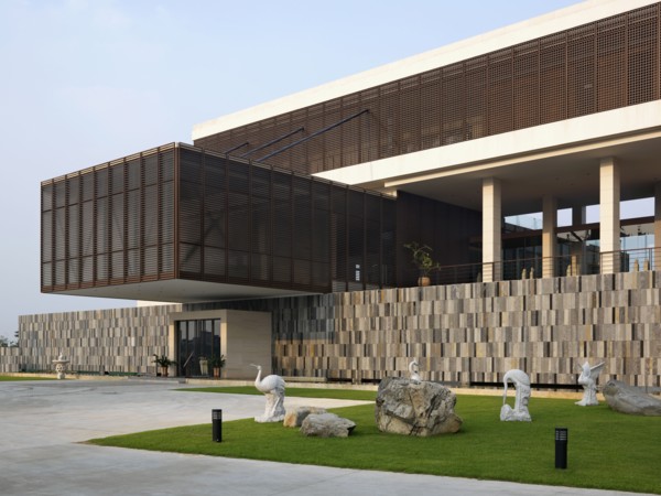 Crane statues on lawn outside modern building