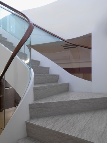 View midway up modern staircase with glass railing