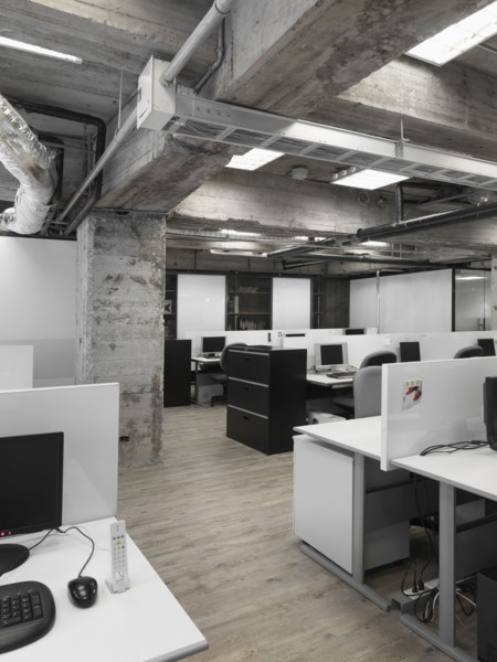 Modern industrial office with rows of computers