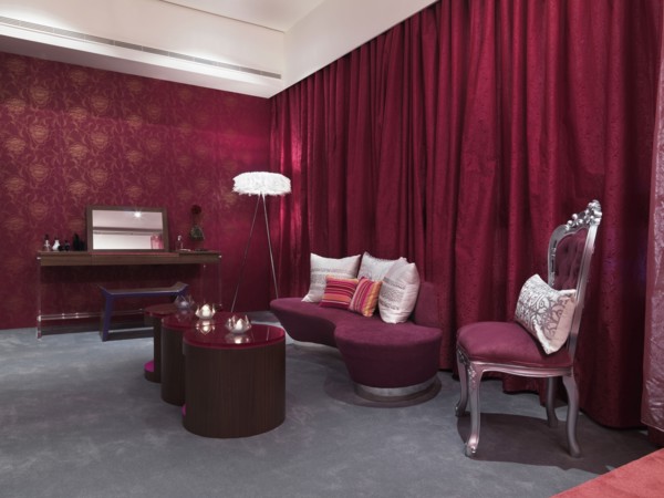 Chic bedroom with pink glass coffee table and grey carpet
