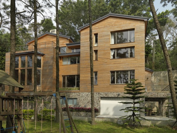 Exterior view of cabin with swing set in backyard