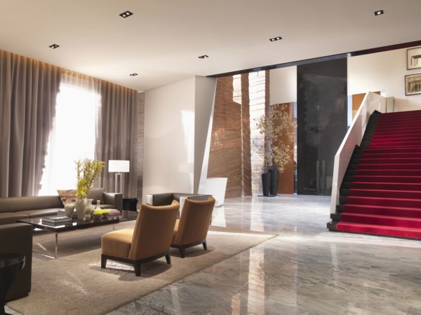 Sitting area and grand red staircase in modern interior