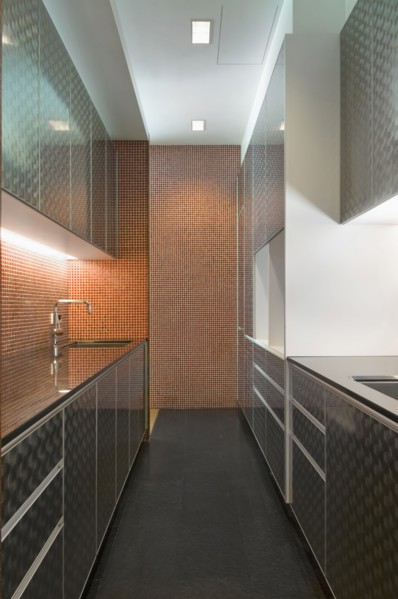 Modern kitchen with cabinets and mosaic tile wall