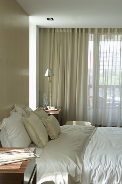 Light colored pillows and comforter on bed