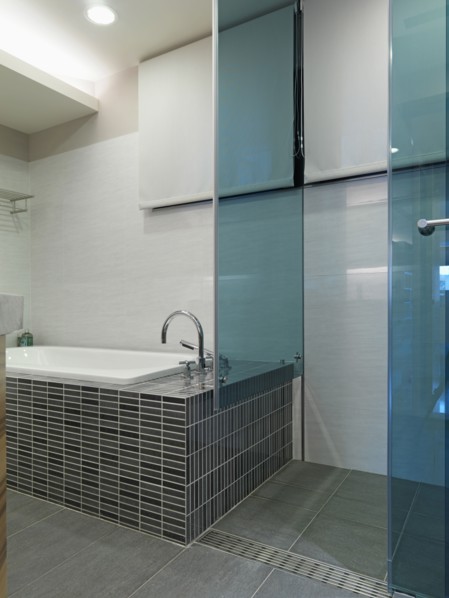 Mosaic tile bathtub and glass shower
