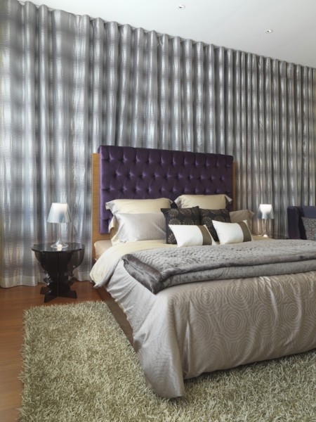 Elegant modern bedroom with purple velvet headboard
